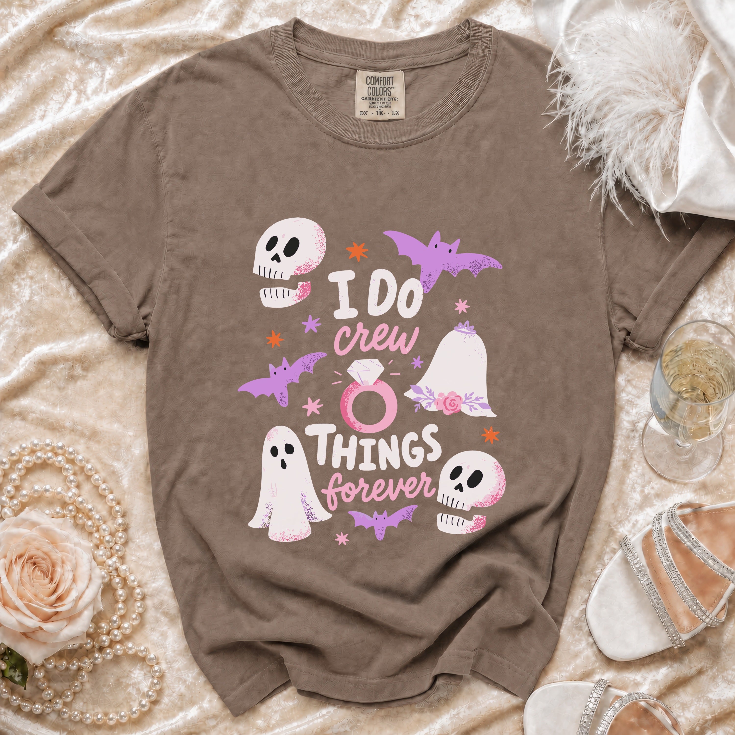 Brown t-shirt with "I DO crew THINGS forever" graphic featuring ghosts, skulls, bats, and wedding ring.