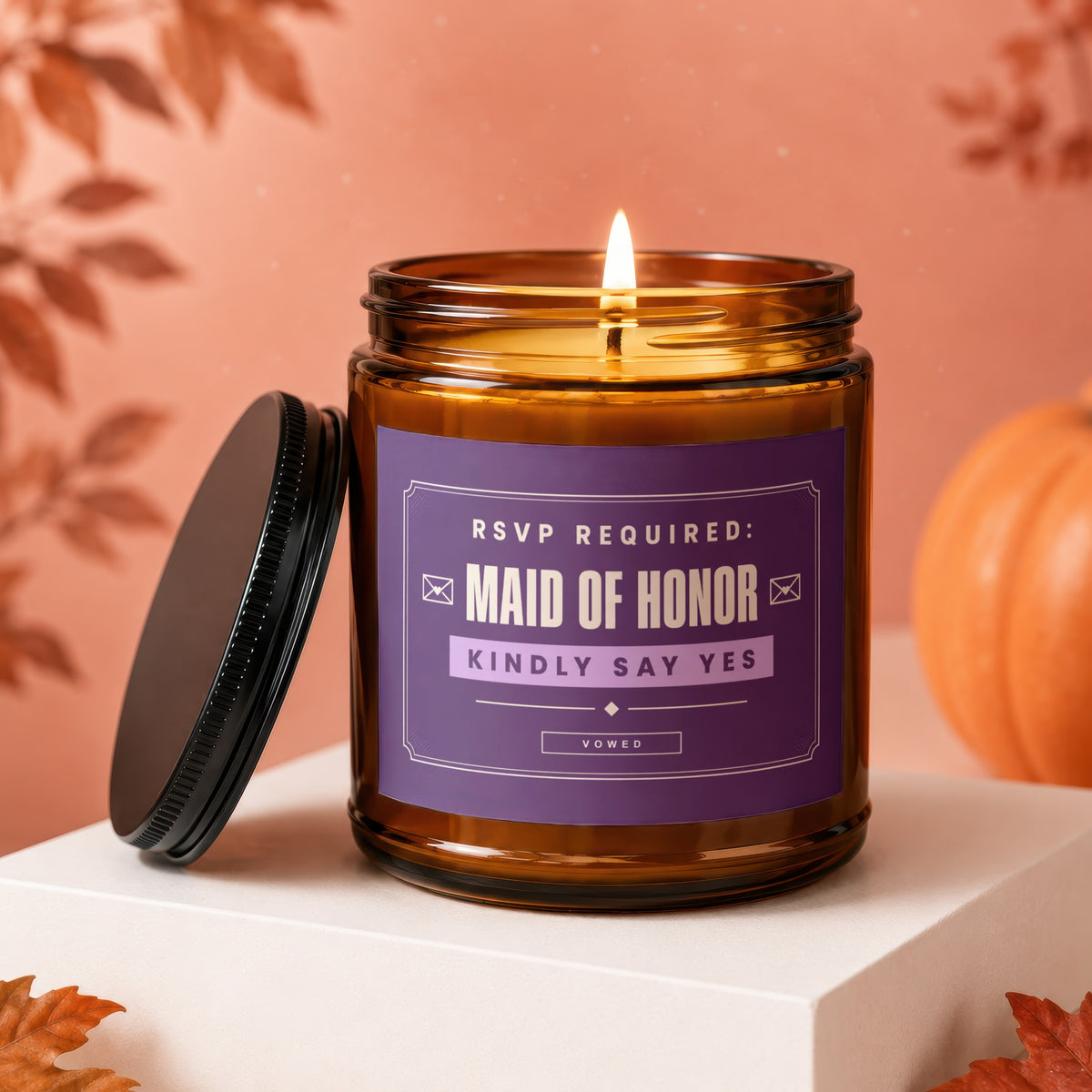 Amber jar candle with lit wick, reads "Maid of Honor Kindly Say Yes".