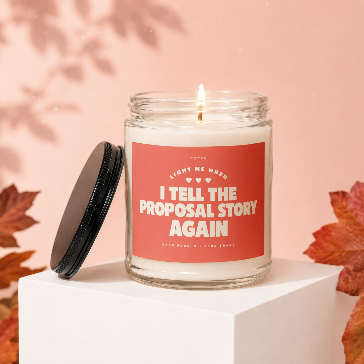 Glass candle with "Light me when I tell the proposal story again" text.