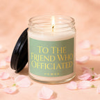 Glass candle with lit wick, green label reading "To The Friend Who Officiated Vowed."