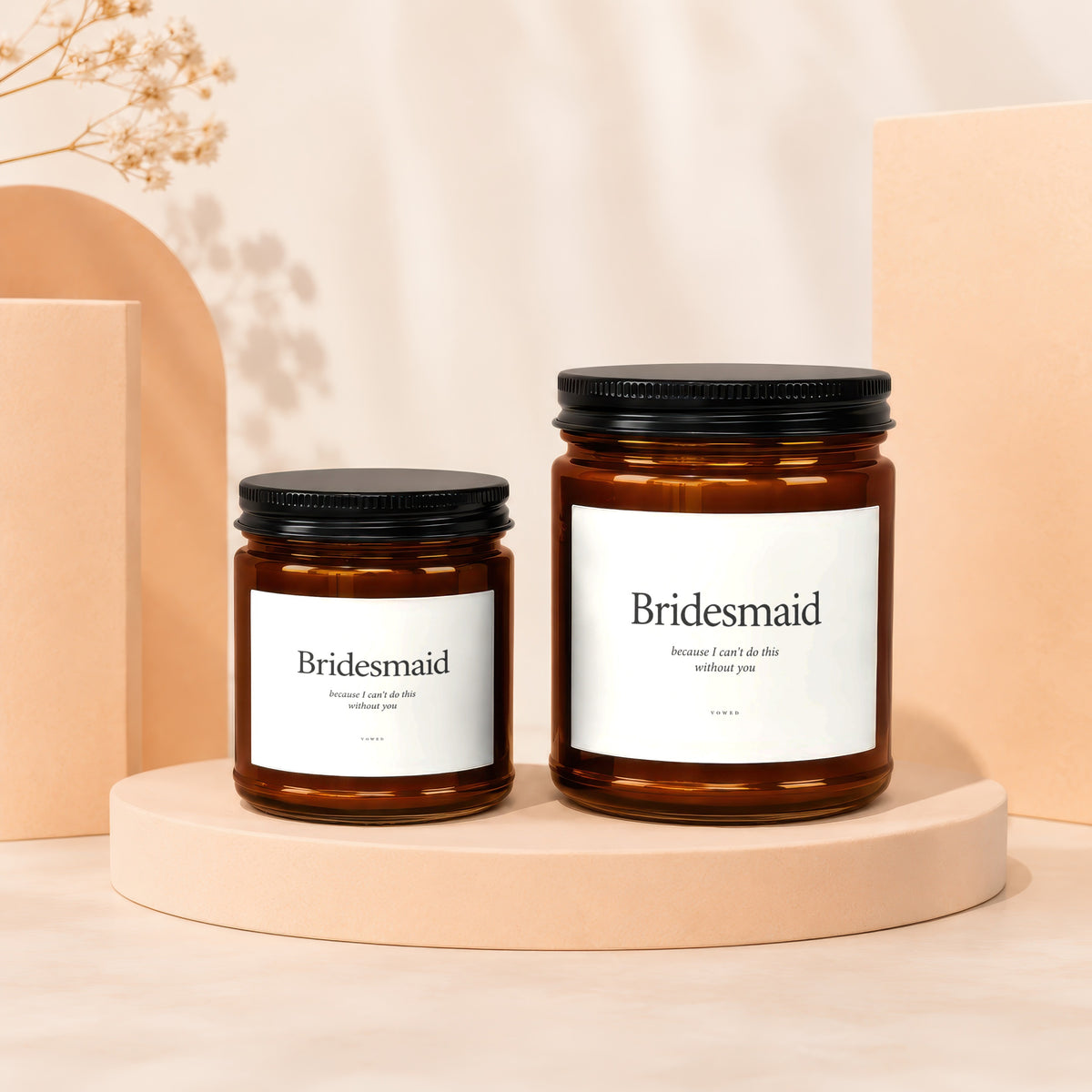 Two amber glass candles with black lids, labeled "Bridesmaid".