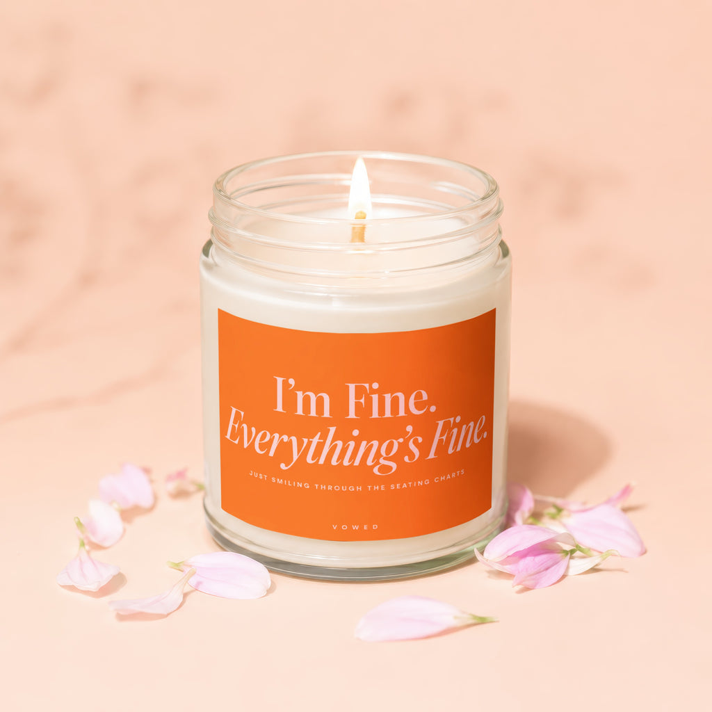 Glass candle with "I'm Fine. Everything's Fine." text and pink petals.