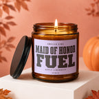 Amber candle with lit wick, reads "Maid of Honor Fuel."