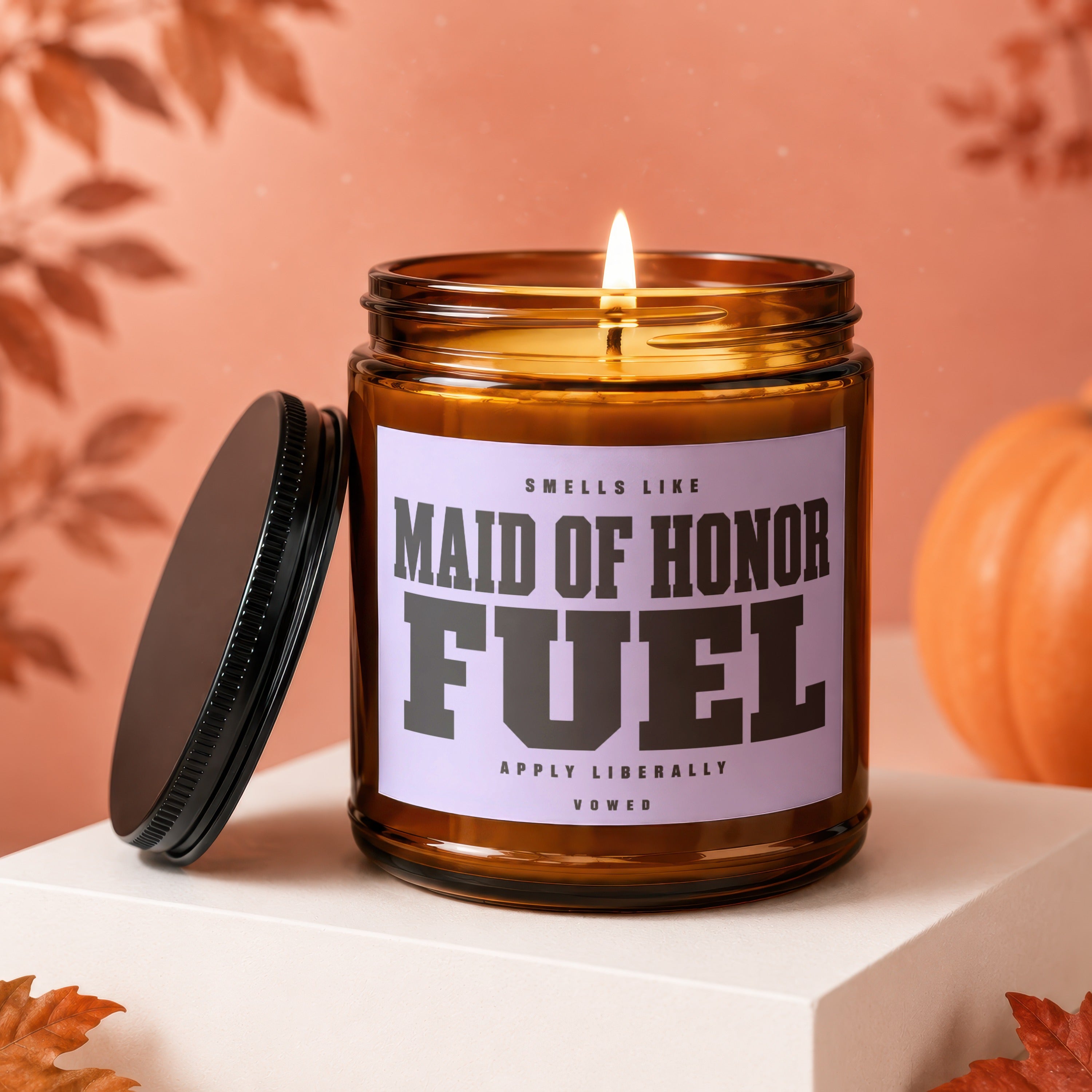 Amber candle with lit wick, reads "Maid of Honor Fuel."