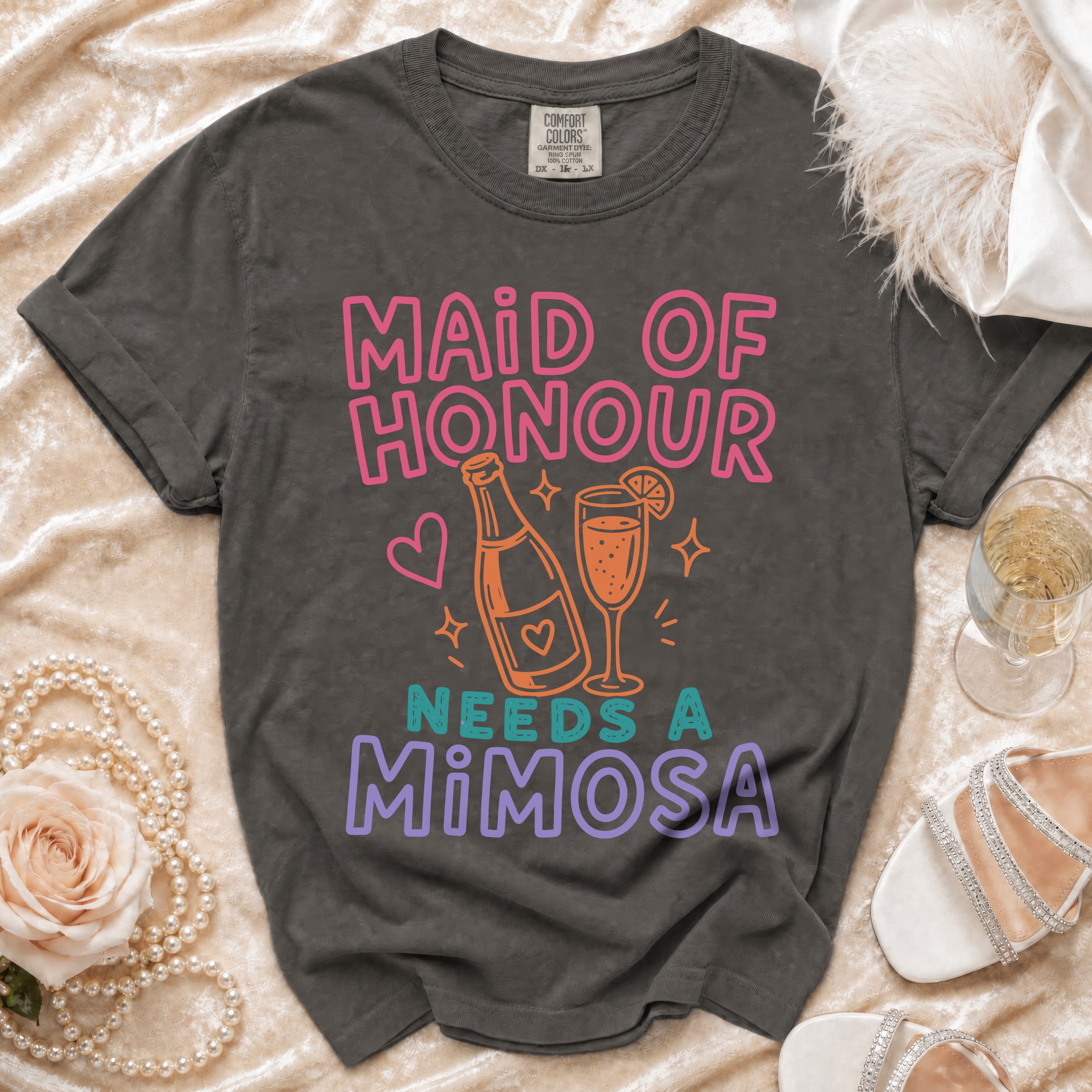 "Maid of Honour Needs a Mimosa" t-shirt with champagne bottle and glass design.