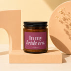 Brown glass candle with "In my bride era." text on a burgundy label.