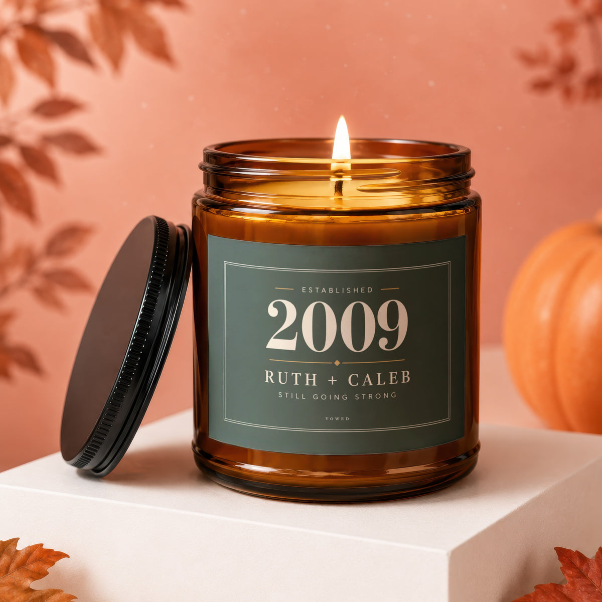 Amber jar candle with "Established 2009 Ruth + Caleb Still Going Strong" label.