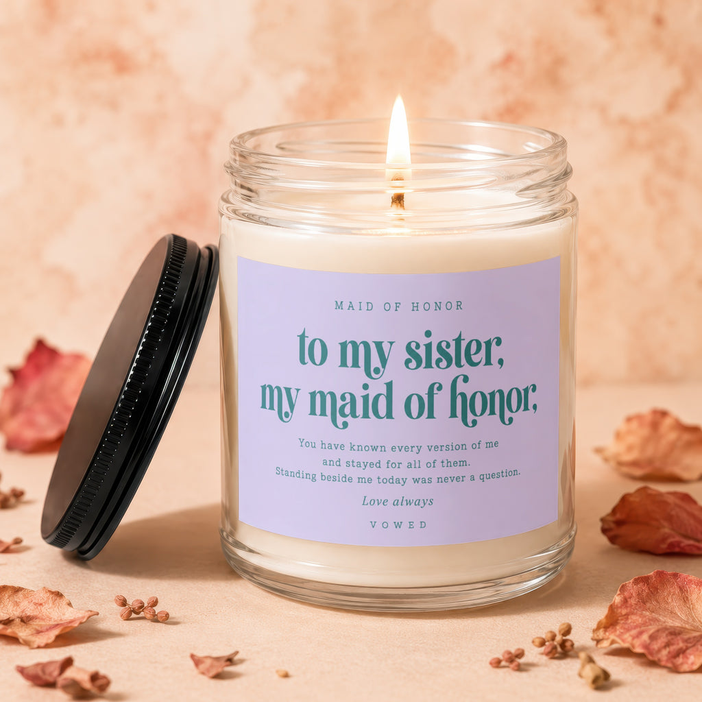 Glass jar candle with "to my sister, my maid of honor" inscription.