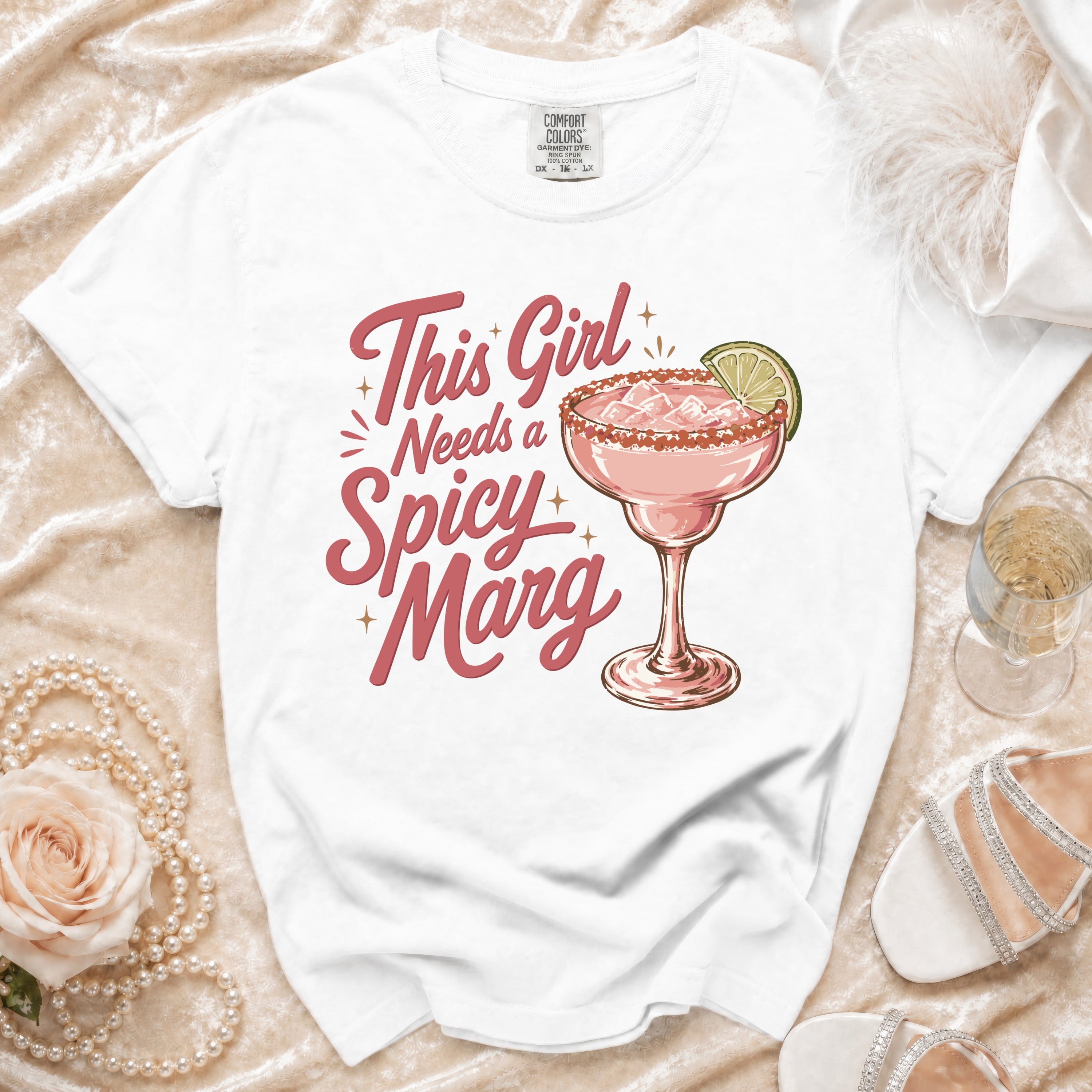 White t-shirt with "This Girl Needs a Spicy Marg" and margarita graphic.