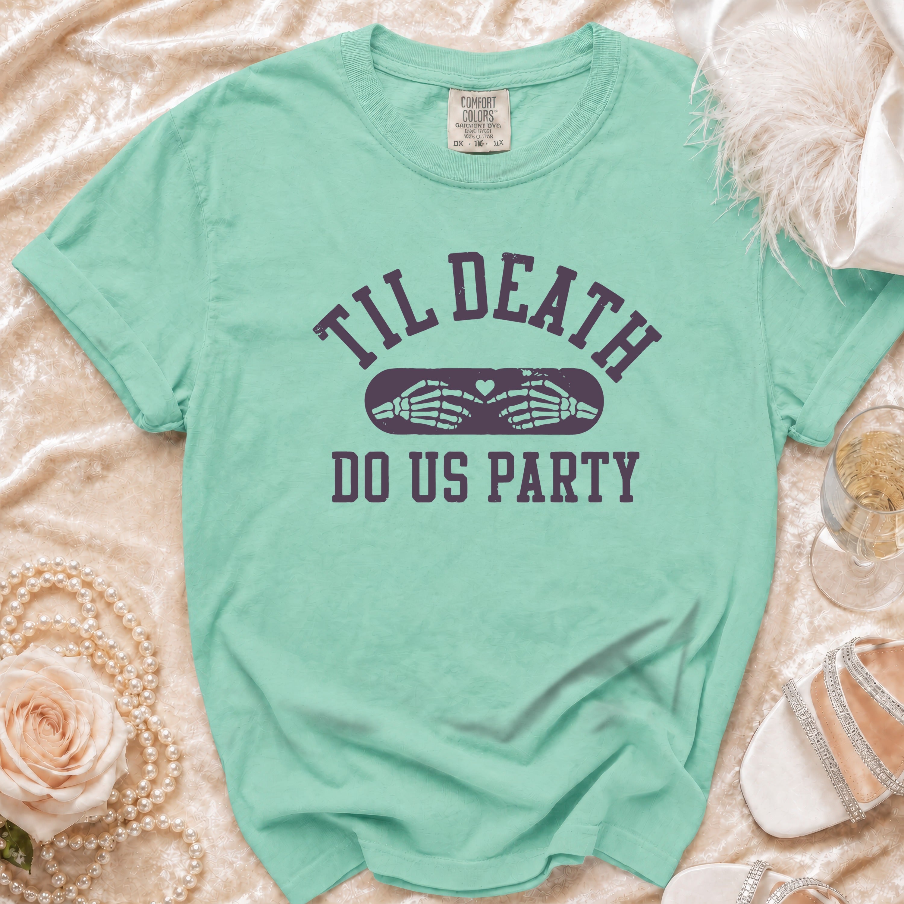 Mint green t-shirt with "Til Death Do Us Party" text and skeleton hands.