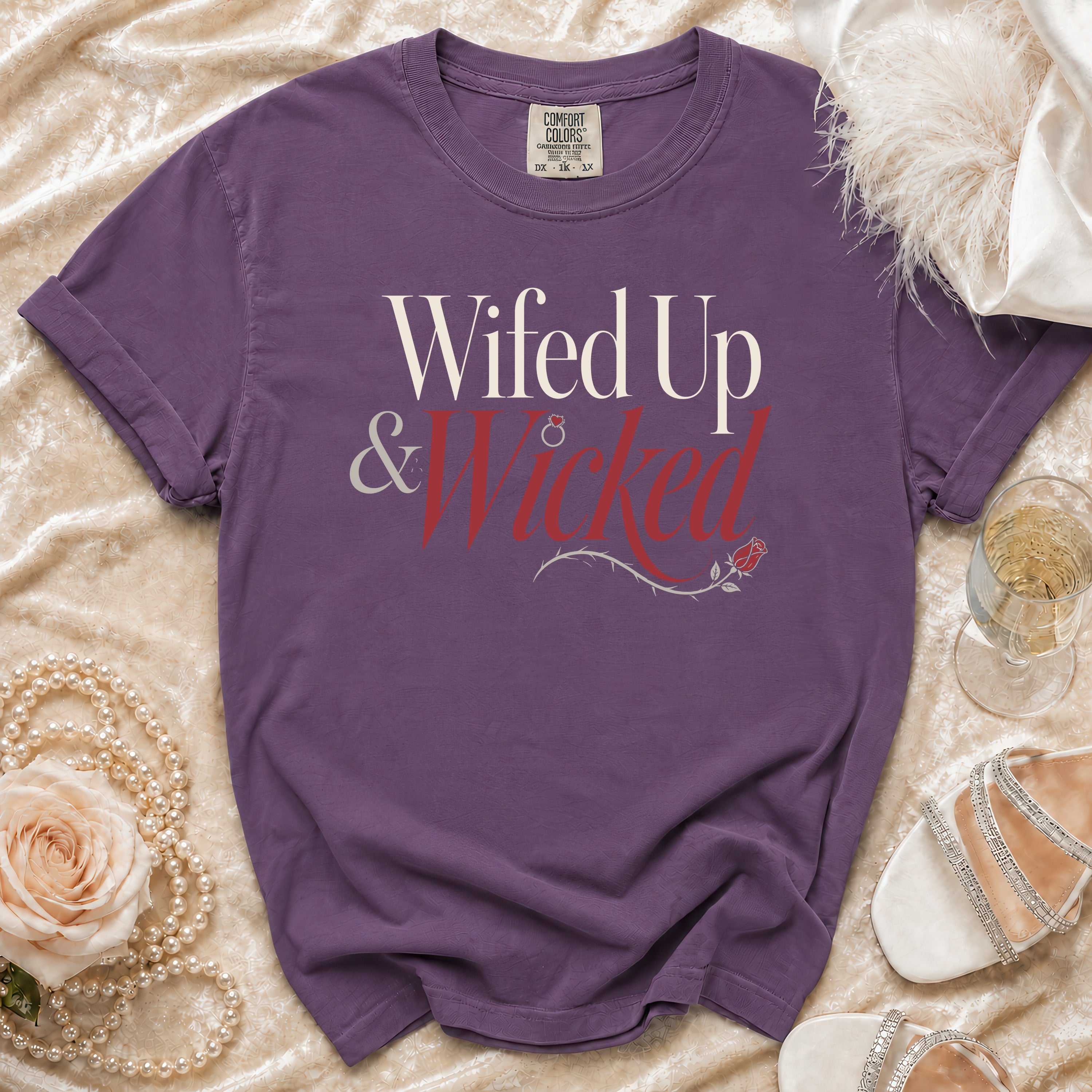 Purple t-shirt with "Wifed Up & Wicked" text and rose design.