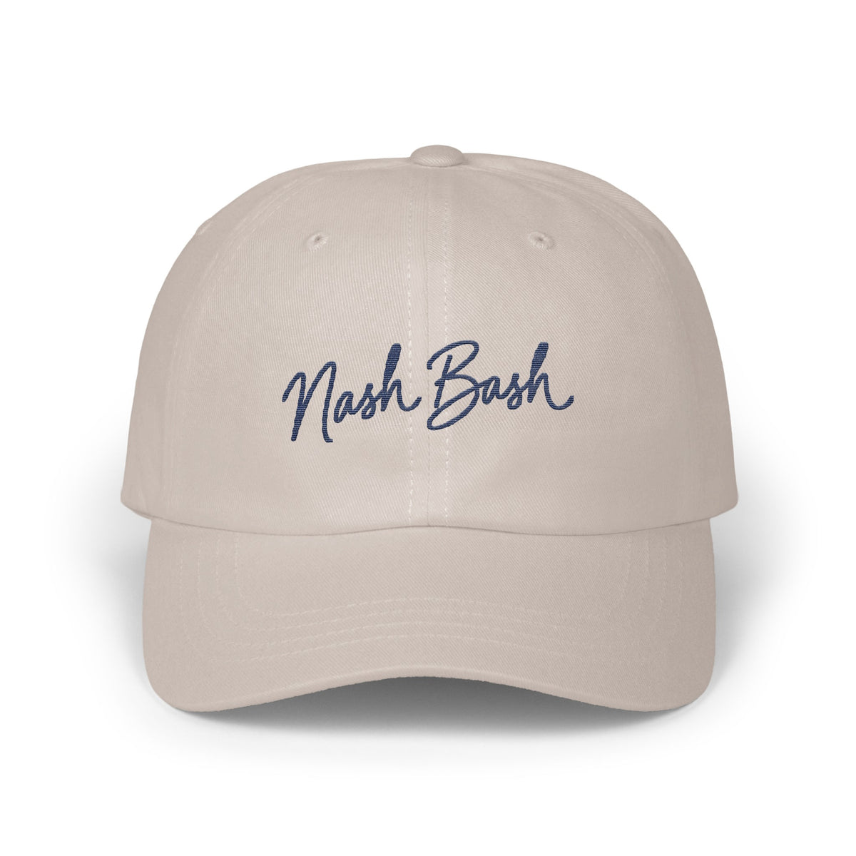 A light beige baseball cap with the blue embroidered text Nash Bash centered on the front.