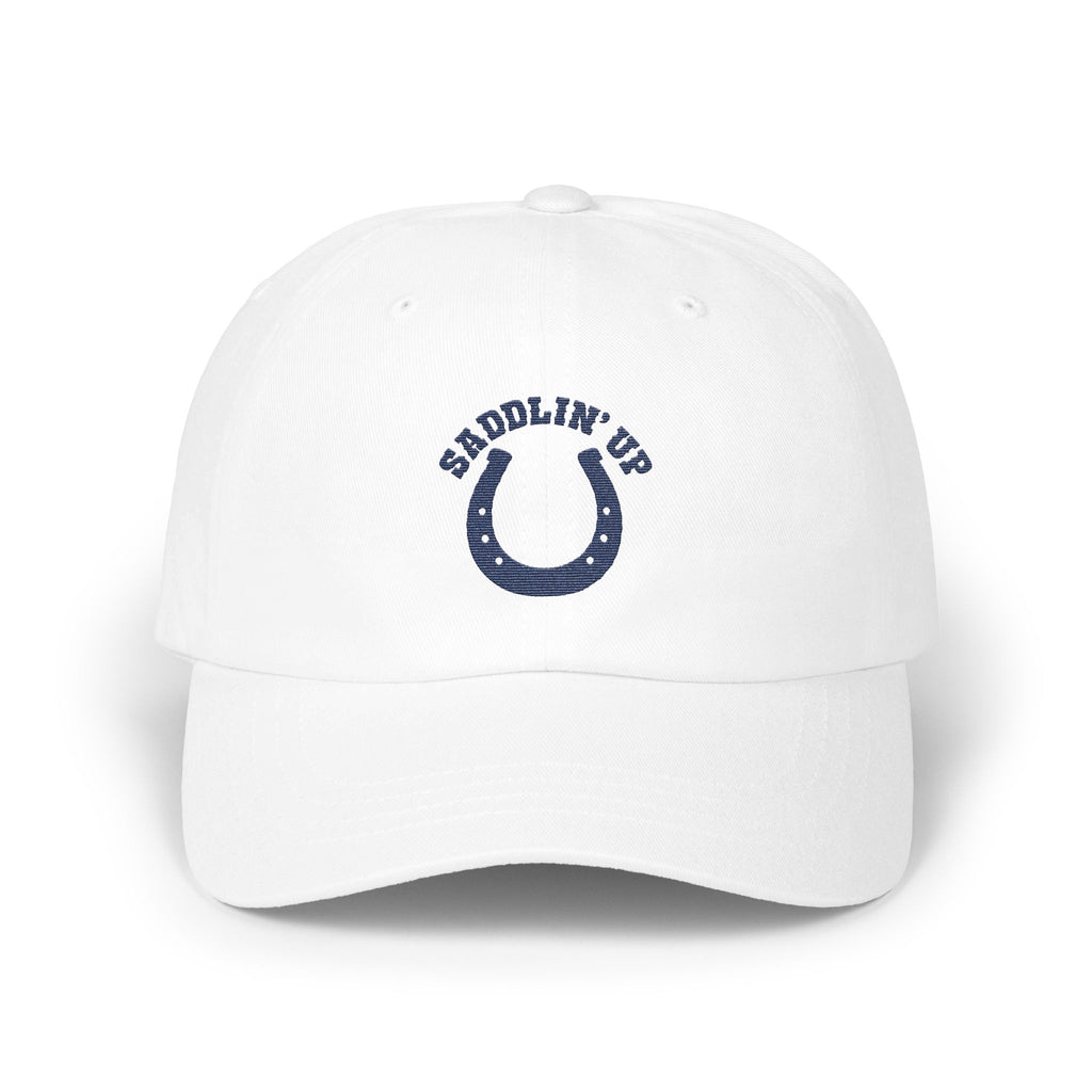 A white baseball cap featuring a blue horseshoe and the text SADDLIN UP on the front.