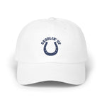 A white baseball cap featuring a blue horseshoe and the text SADDLIN UP on the front.