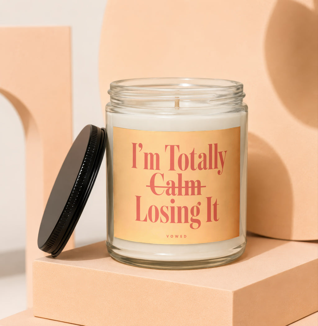 Candle with text "I'm Totally Calm Losing It" on a peach colored label.