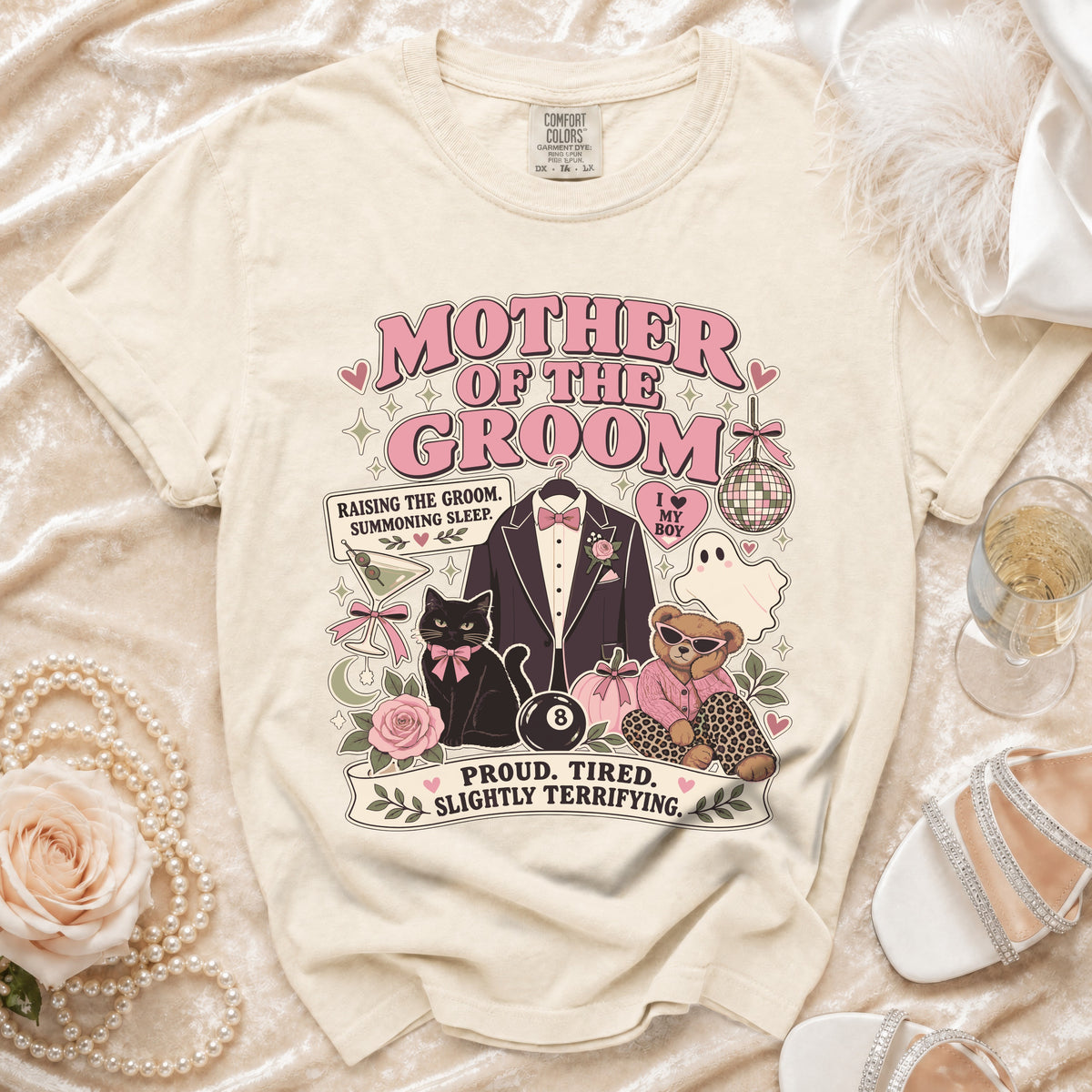 Cream t-shirt with "Mother of the Groom" graphic, tuxedo, cat, teddy bear, and text.