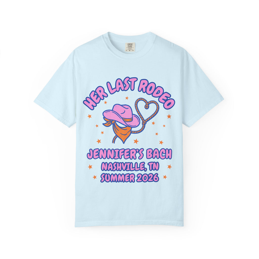 Light blue t-shirt with "Her Last Rodeo" text, cowboy hat, lasso, and Nashville details.