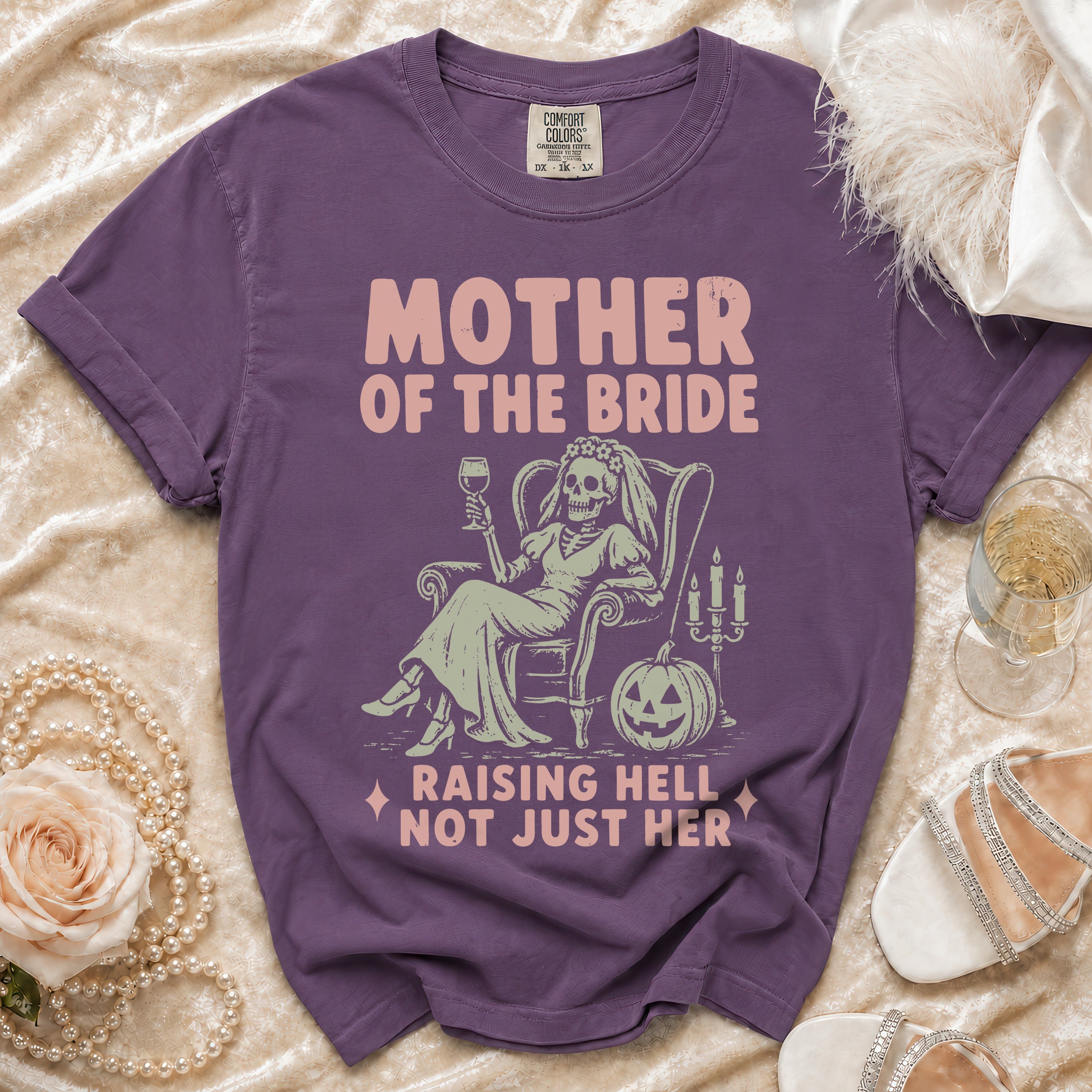 Purple t-shirt with "Mother of the Bride Raising Hell Not Just Her" graphic.