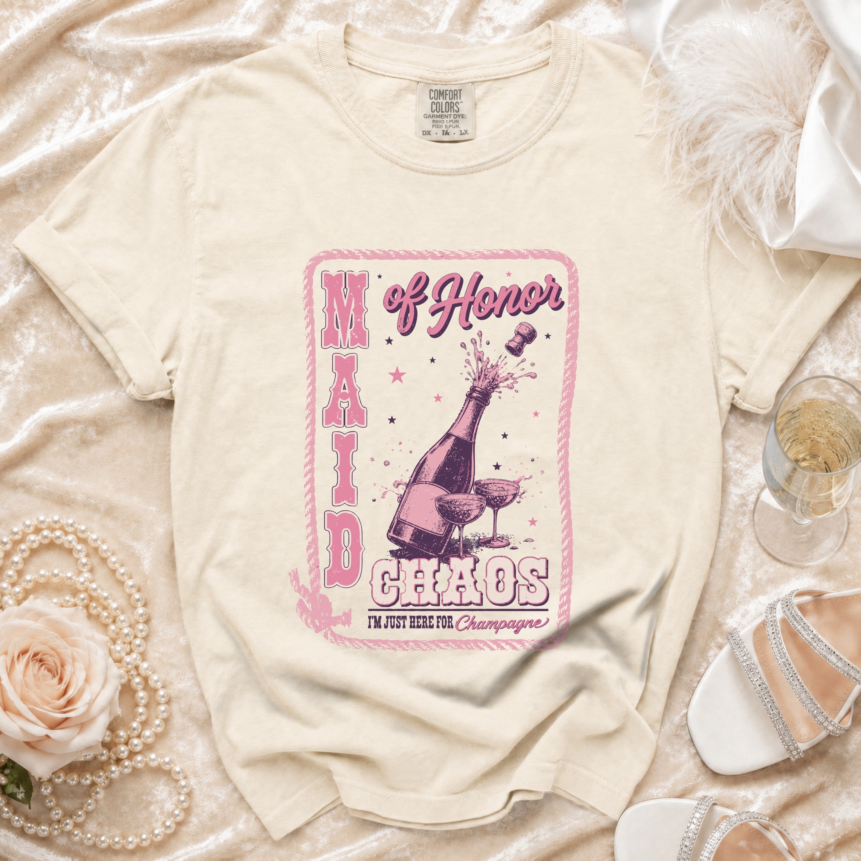 T-shirt with "Maid of Honor Chaos I'm Just Here for Champagne" graphic and champagne bottle.