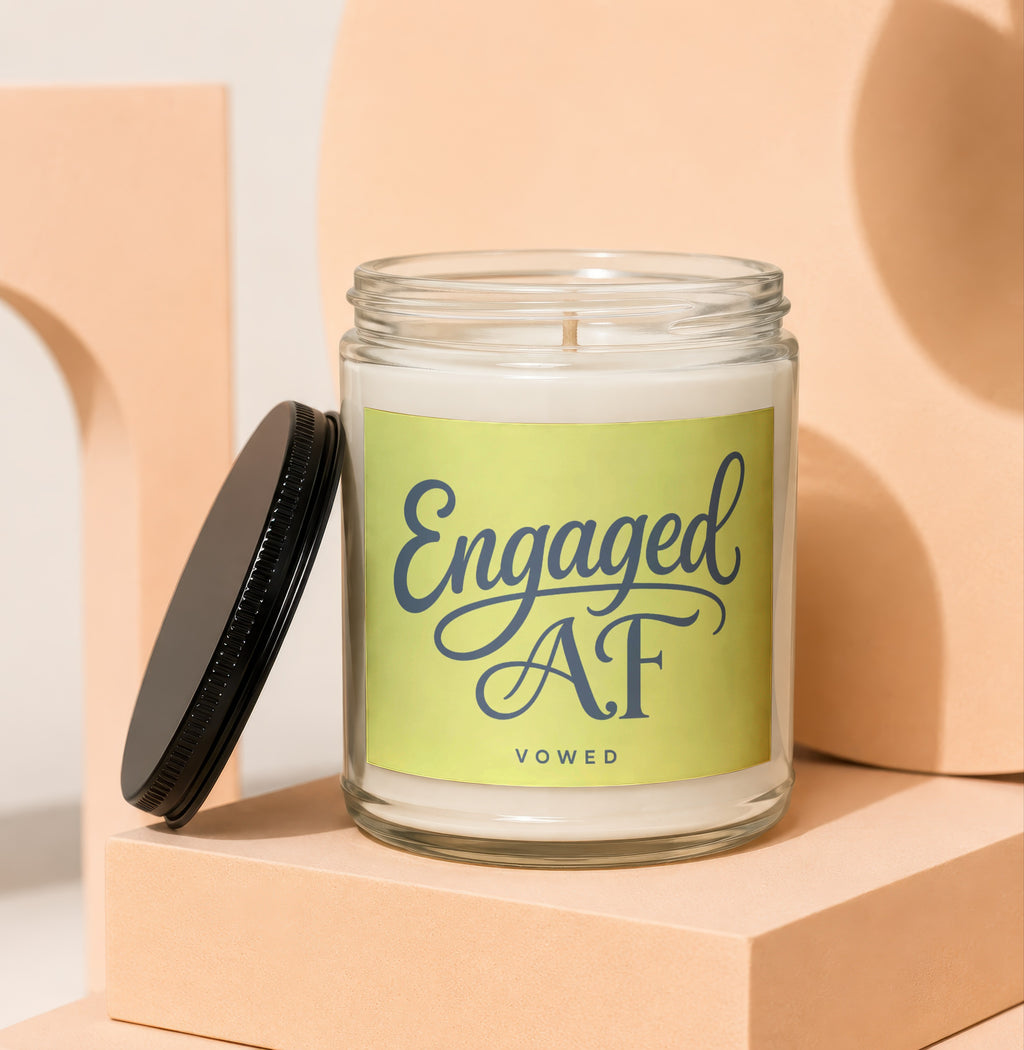 Glass candle with "Engaged AF VOWED" text on a light green label.
