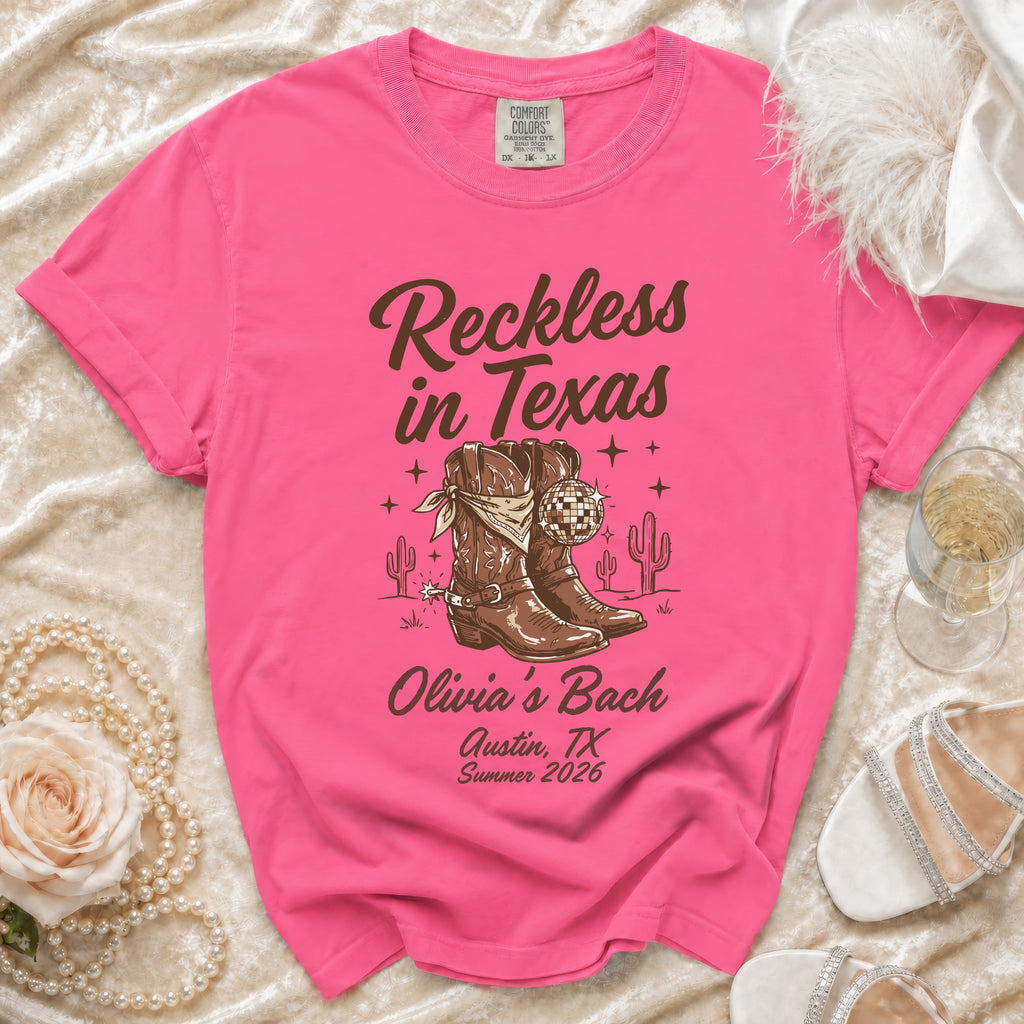 Pink t-shirt with "Reckless in Texas" and "Olivia's Bach Austin, TX Summer 2026" graphics.
