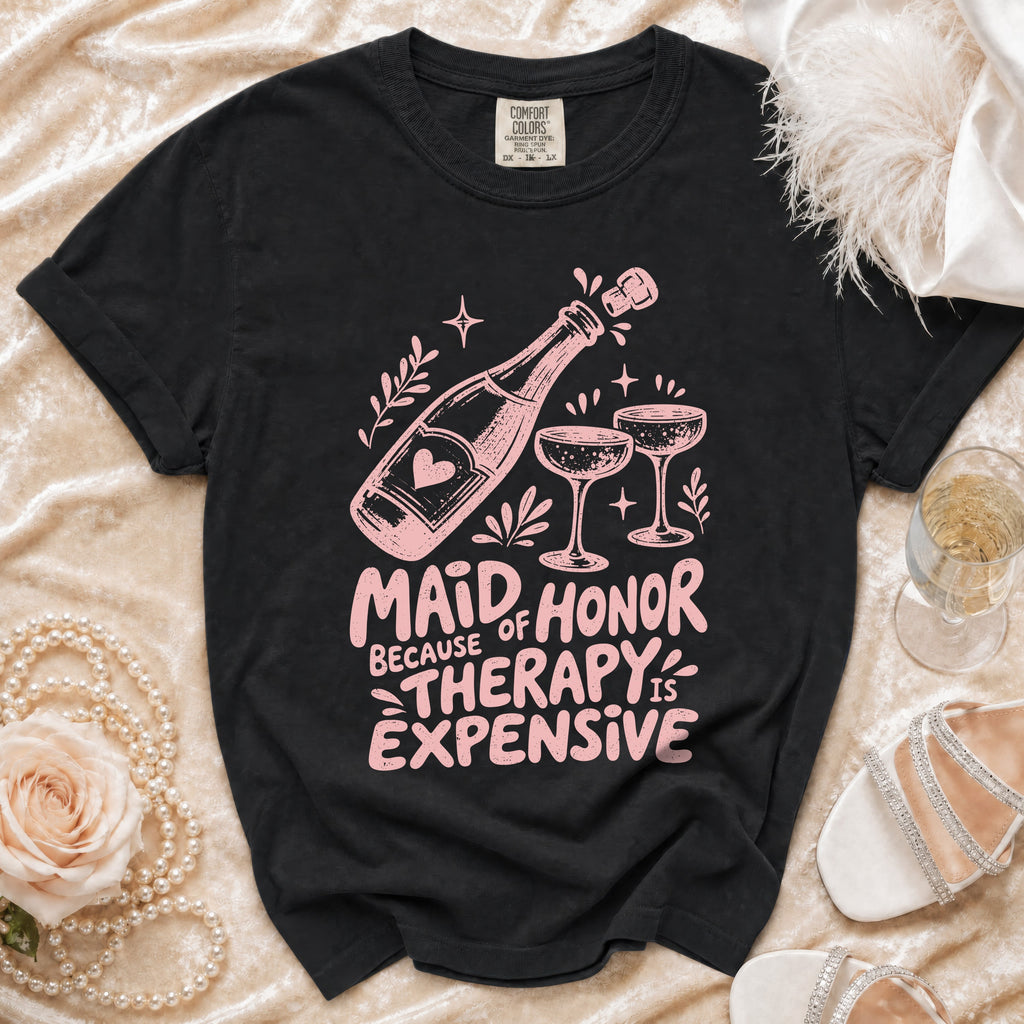 Black t-shirt with "Maid of Honor Because Therapy is Expensive" text and champagne graphics.