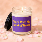 Candle with purple label reading "Stuck With Me, Maid of Honor" by Vowed.