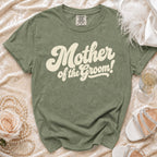 Olive green t-shirt with "Mother of the Groom!" text and wedding accessories.