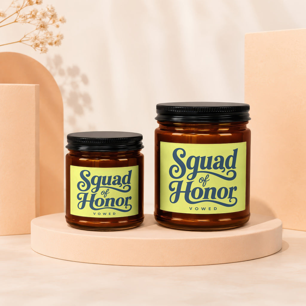 Two amber glass candles with black lids and "Squad of Honor" labels.