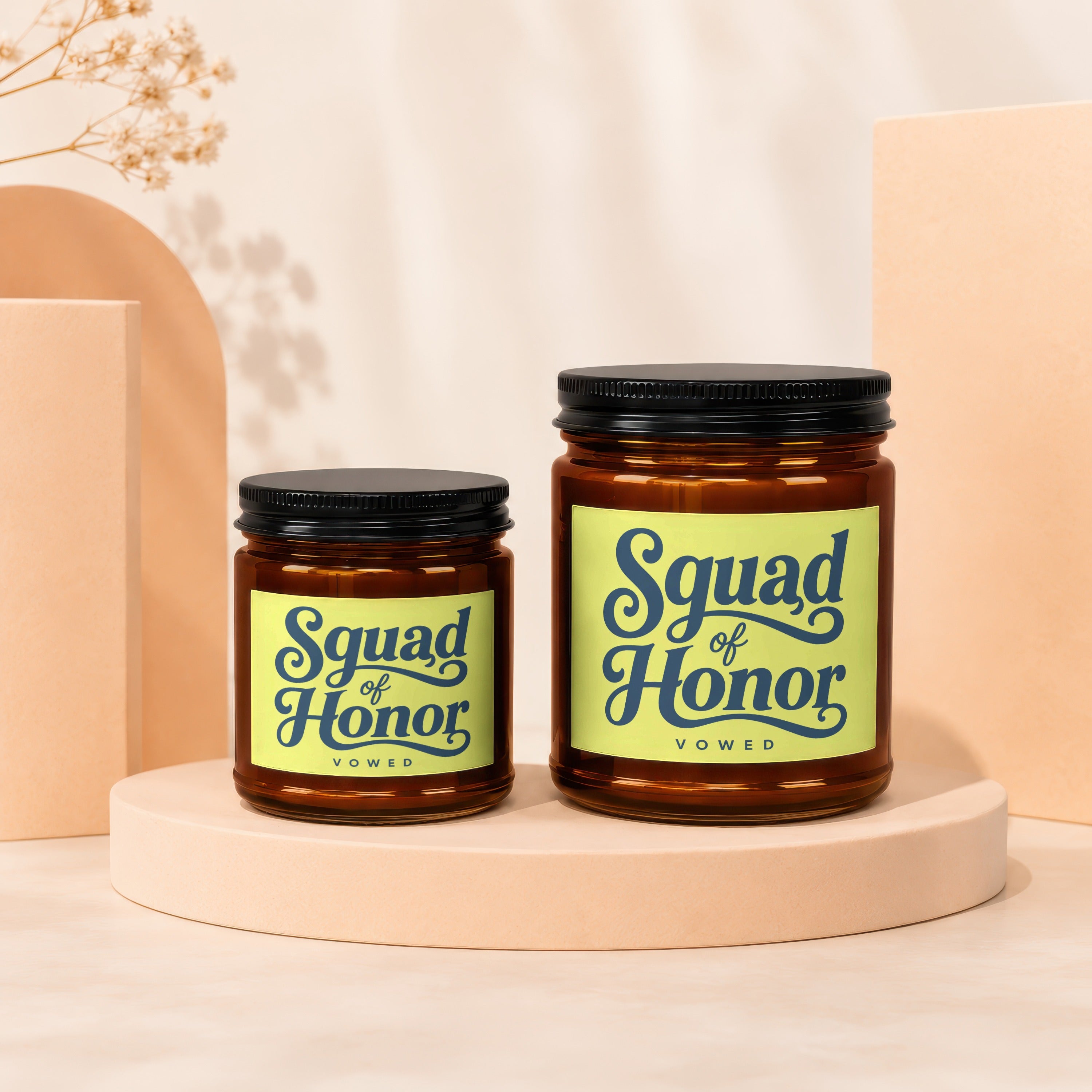 Two amber glass candles with black lids and "Squad of Honor" labels.