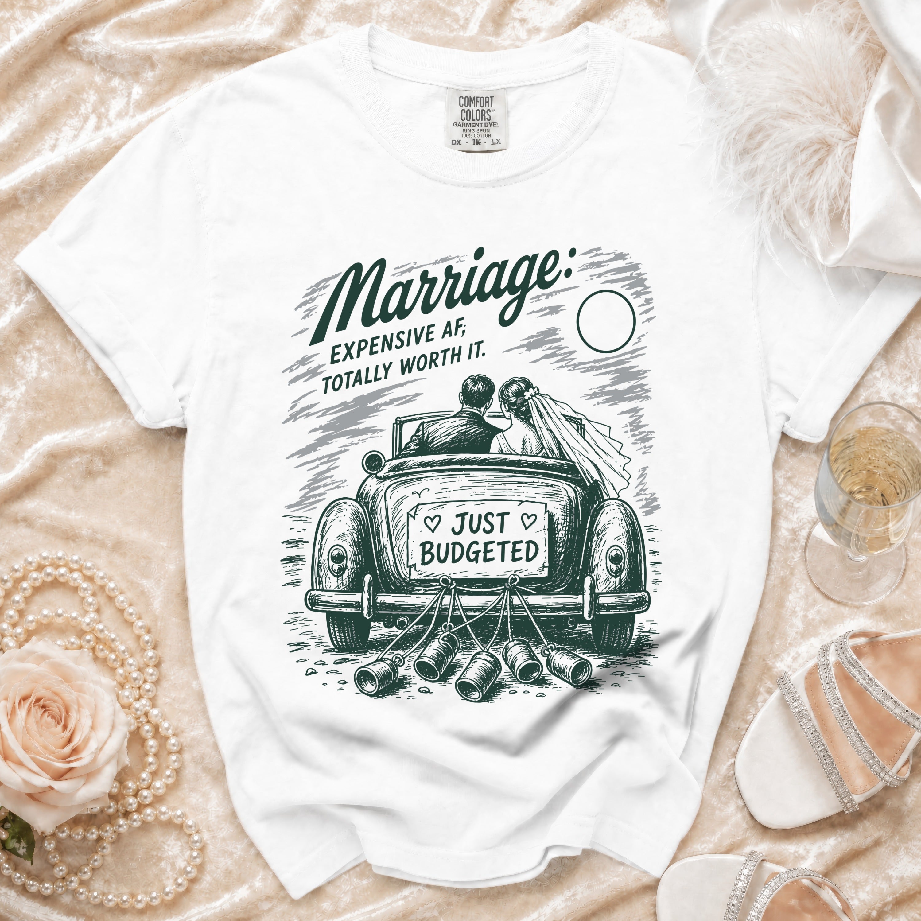 White t-shirt with "Marriage: Expensive AF, Totally Worth It" graphic and "Just Budgeted" on car.