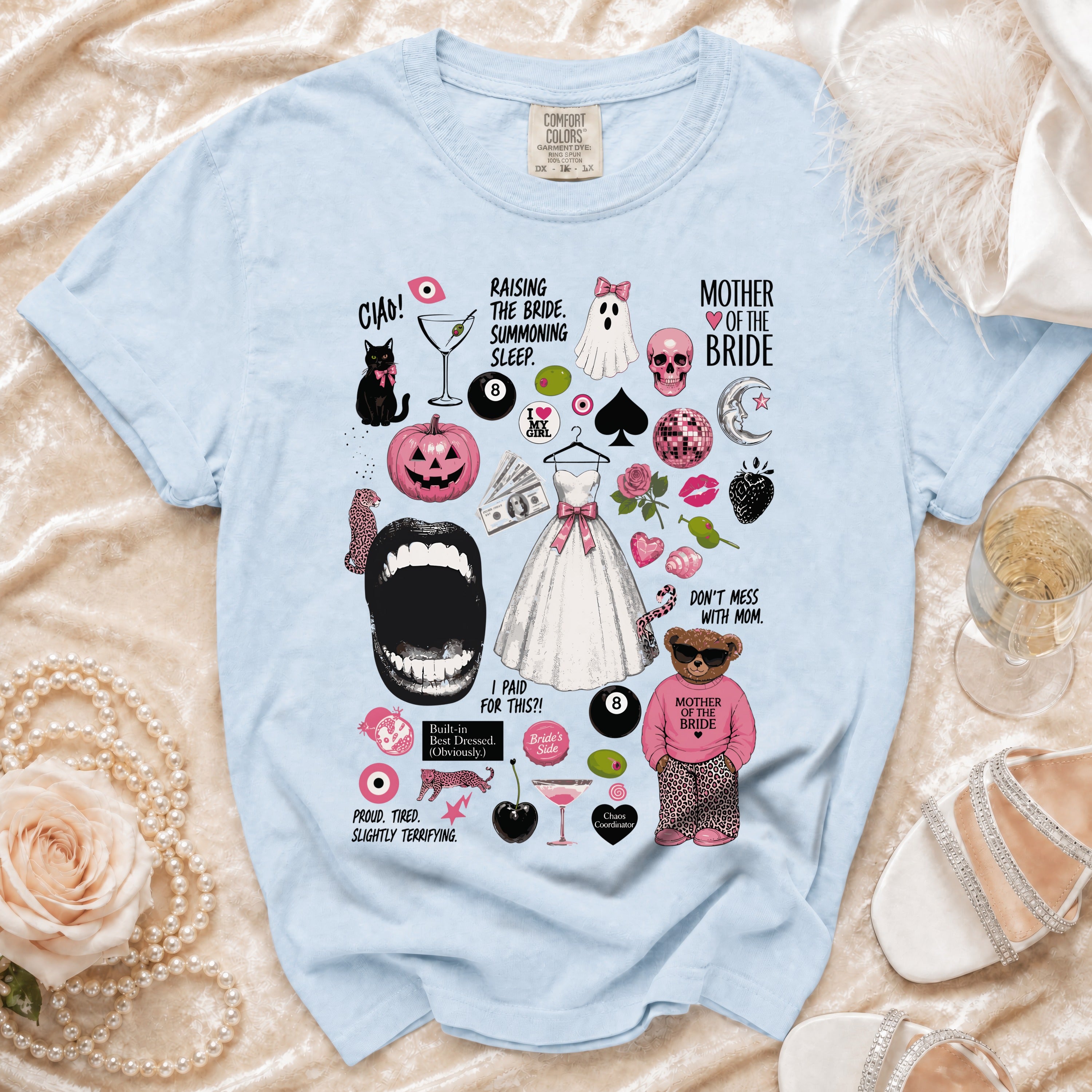Light blue t-shirt with "Mother of the Bride" graphic and wedding-themed illustrations.