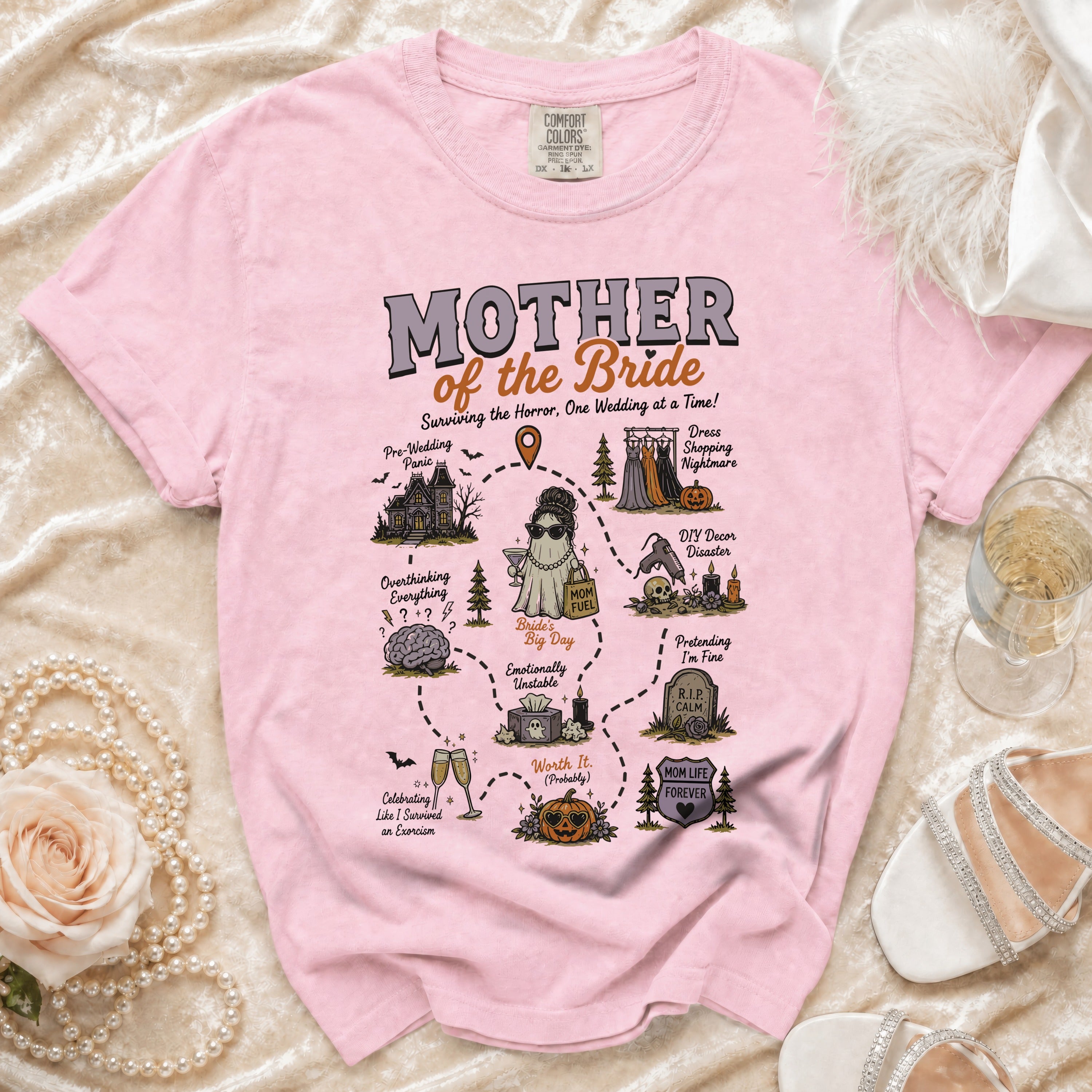 Pink t-shirt with "Mother of the Bride" graphic depicting wedding-related chaos.