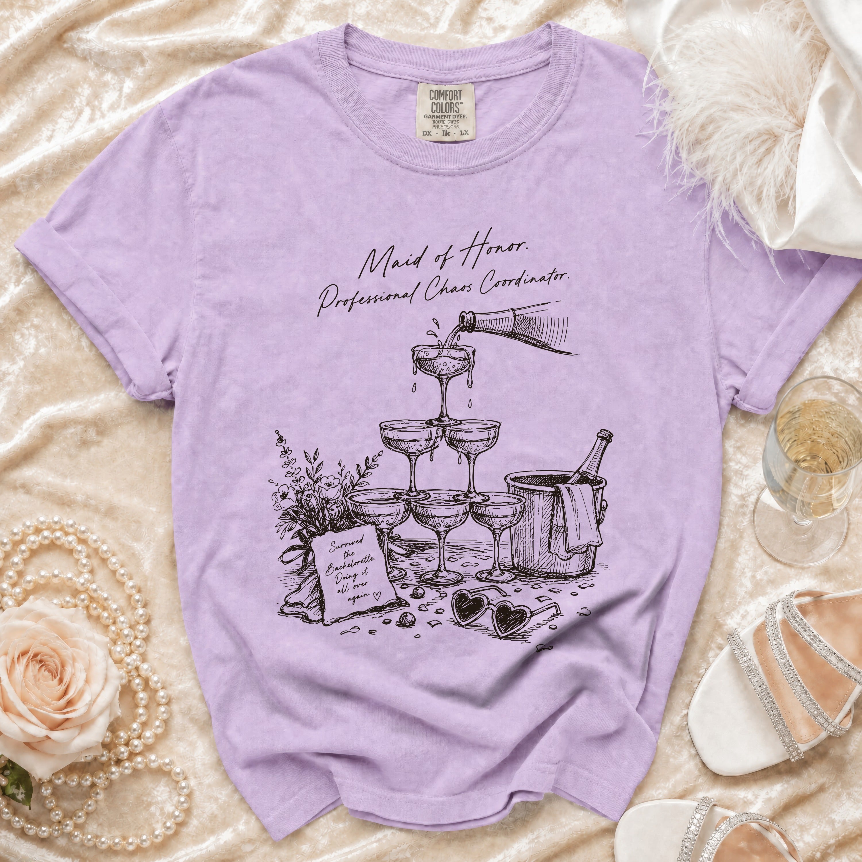 Purple t-shirt with sketch of champagne tower, "Maid of Honor. Professional Chaos Coordinator." text.