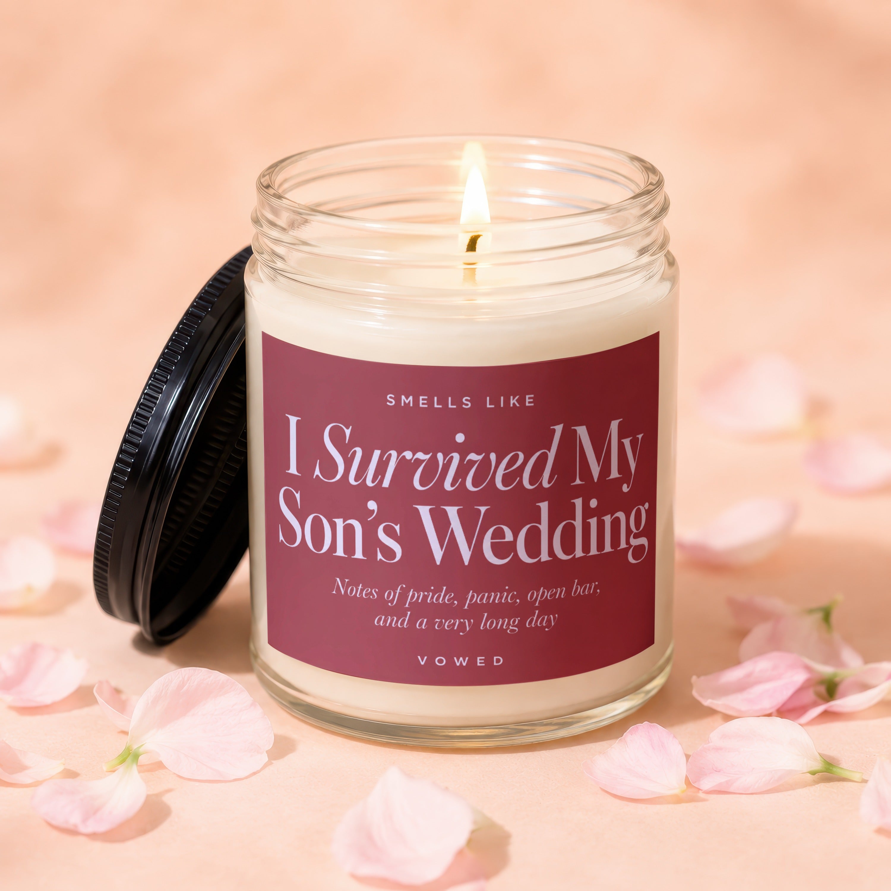 Jar candle with "I Survived My Son's Wedding" scent description and "VOWED".