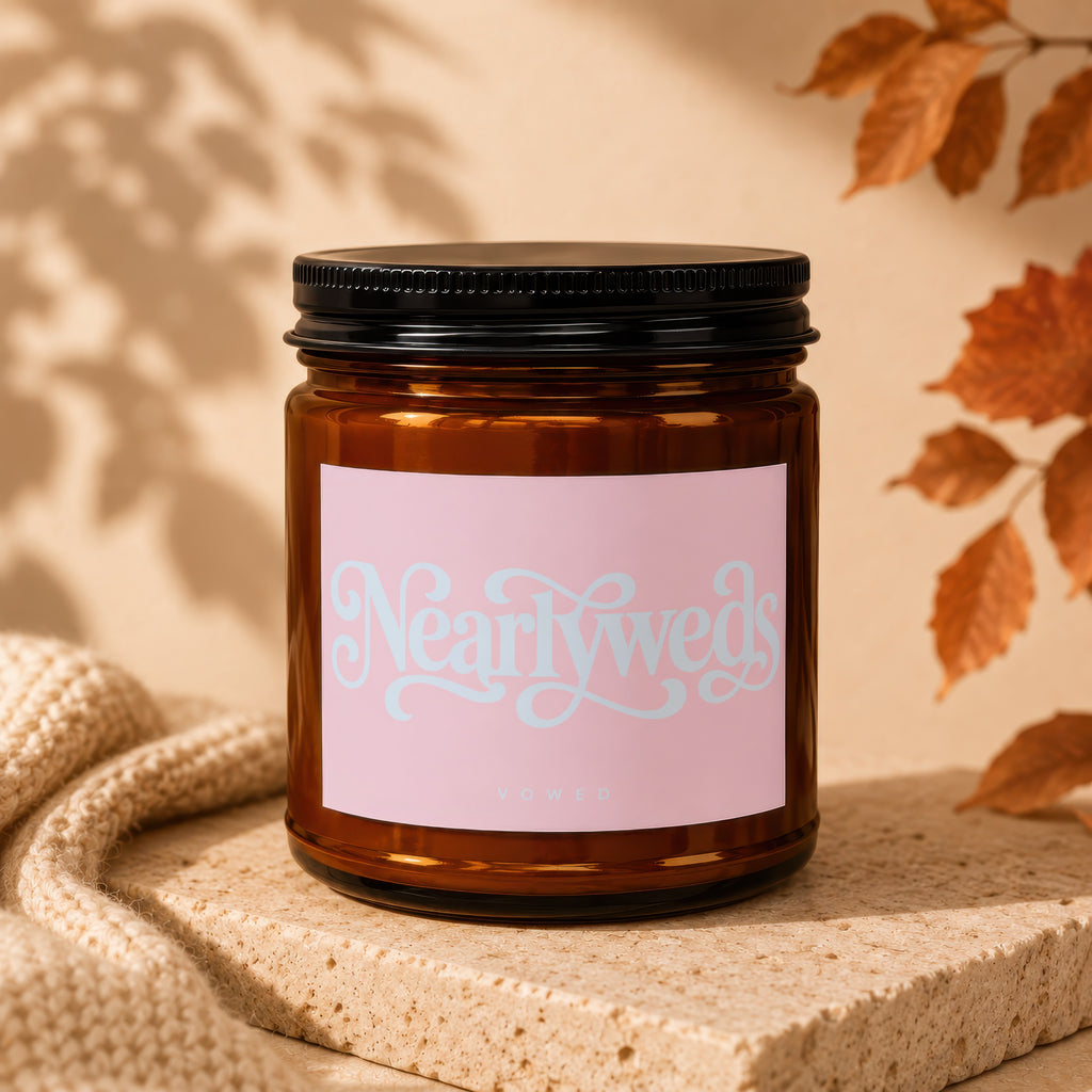 Amber candle jar with a pink label that says "Nearlyweds VOWED".
