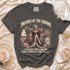 Dark t-shirt with "Mother of the Groom" skeleton graphic and humorous text.