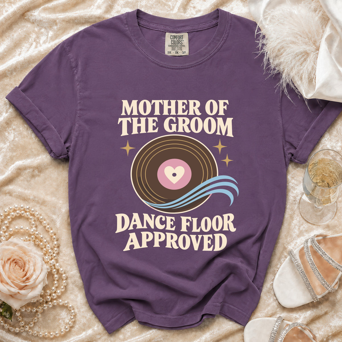 Purple t-shirt with "Mother of the Groom Dance Floor Approved" graphic.