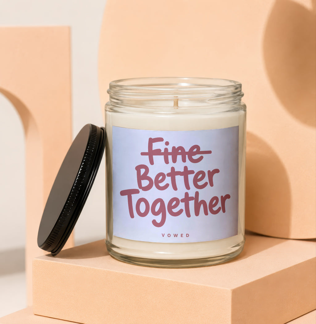 Glass candle with "Fine Better Together" text and a black lid.