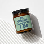 Amber jar candle with label "Est. Someday The Day We Said I Do Vowed".