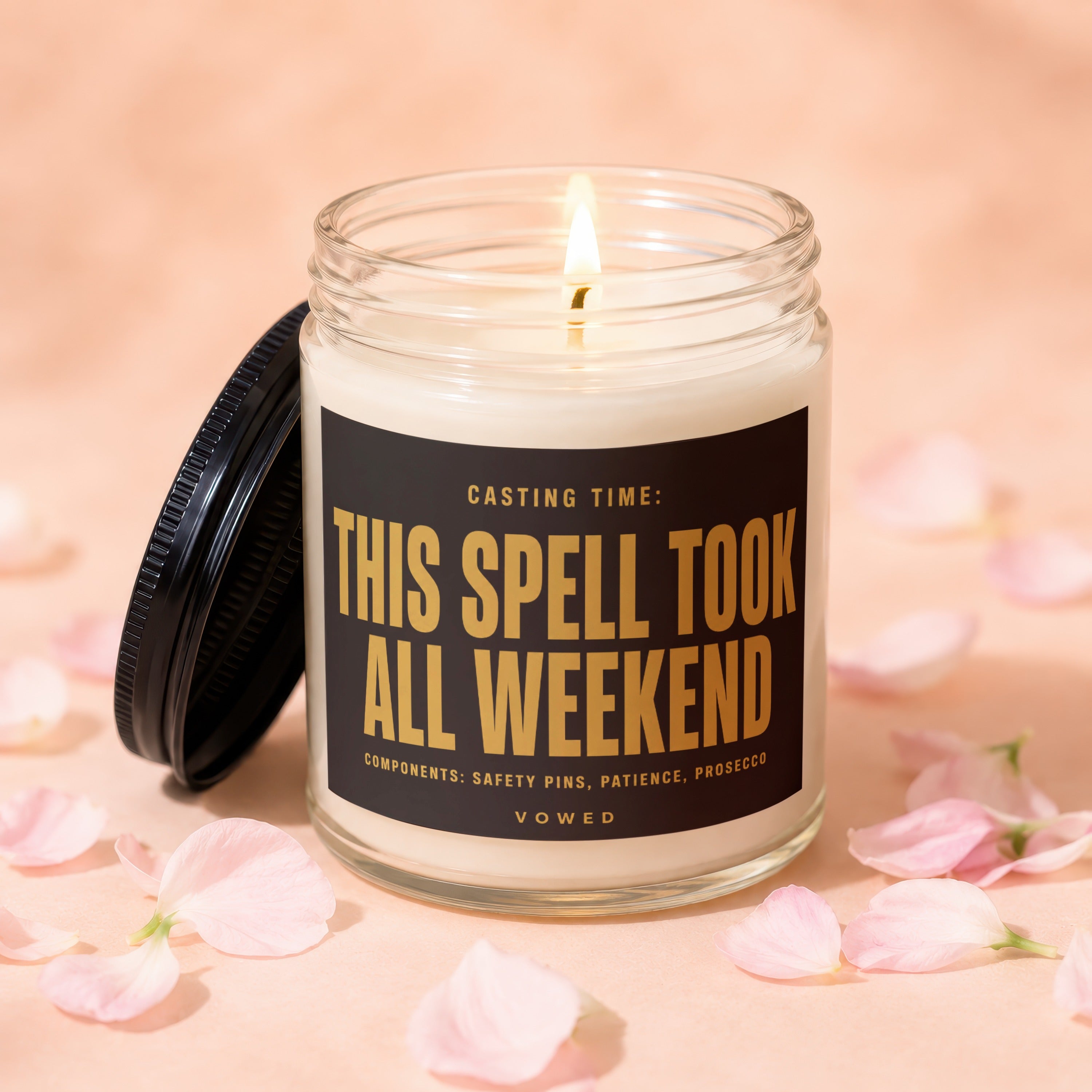 Jar candle with lit wick and black lid, "This Spell Took All Weekend" text.