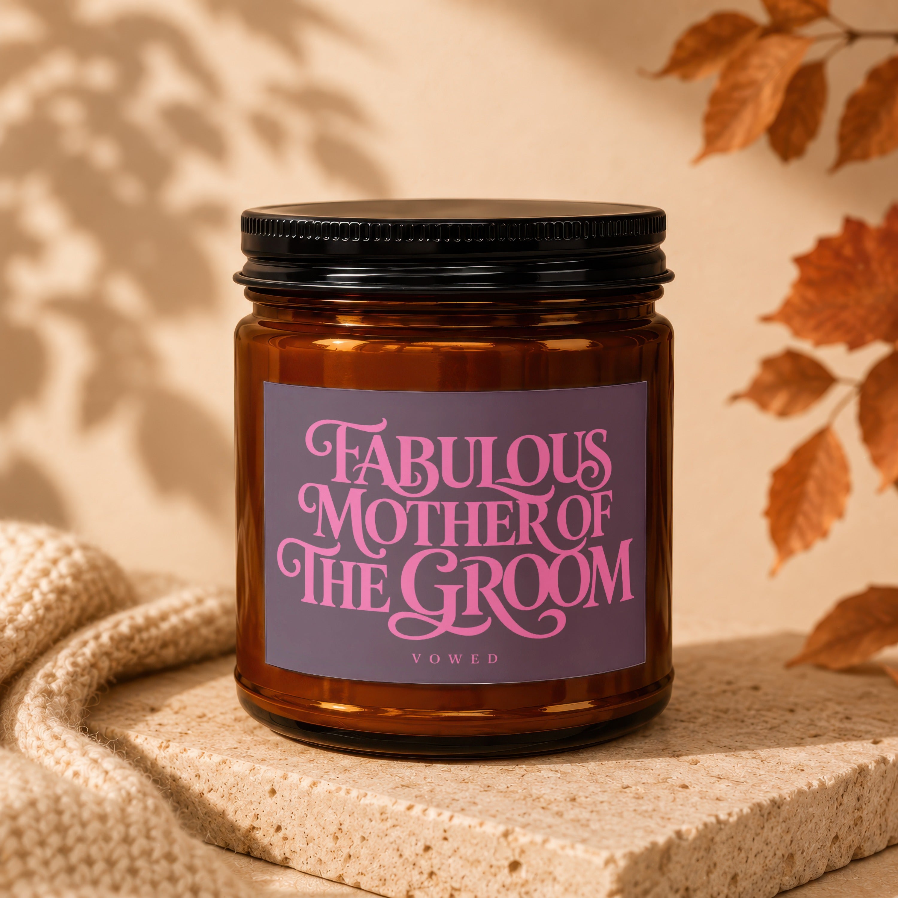 Amber glass candle with a purple label reading "Fabulous Mother of the Groom".