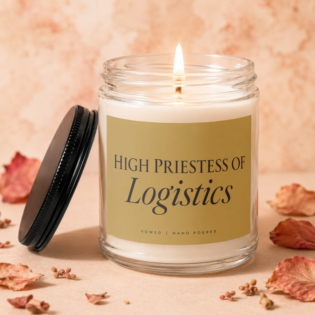 Candle with "High Priestess of Logistics" text, lit flame, black lid.