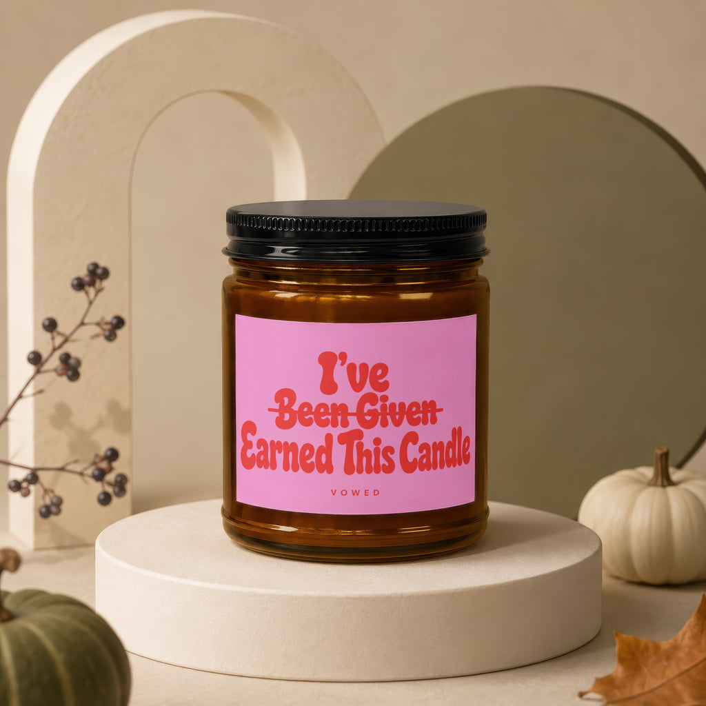 Amber jar candle with pink label that reads "I've Been Given Earned This Candle".