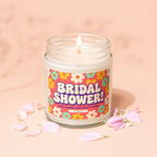 Bridal Shower candle with floral label and pink petals, reads "GIFTS, GAMES AND HAPPY TEARS."