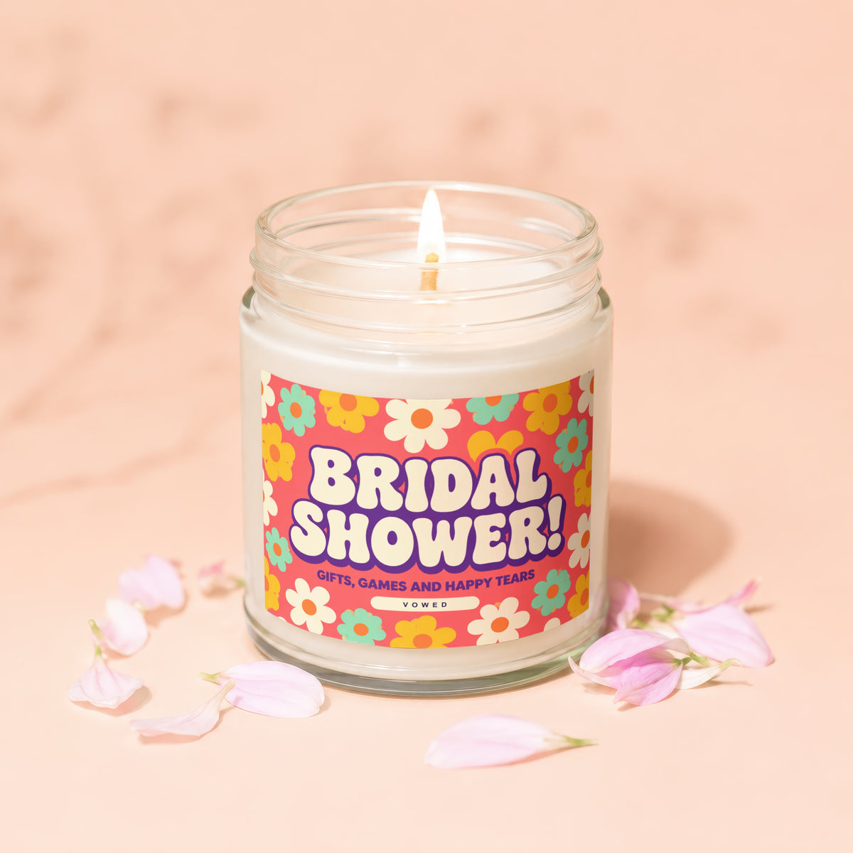 Bridal Shower candle with floral label and pink petals, reads "GIFTS, GAMES AND HAPPY TEARS."