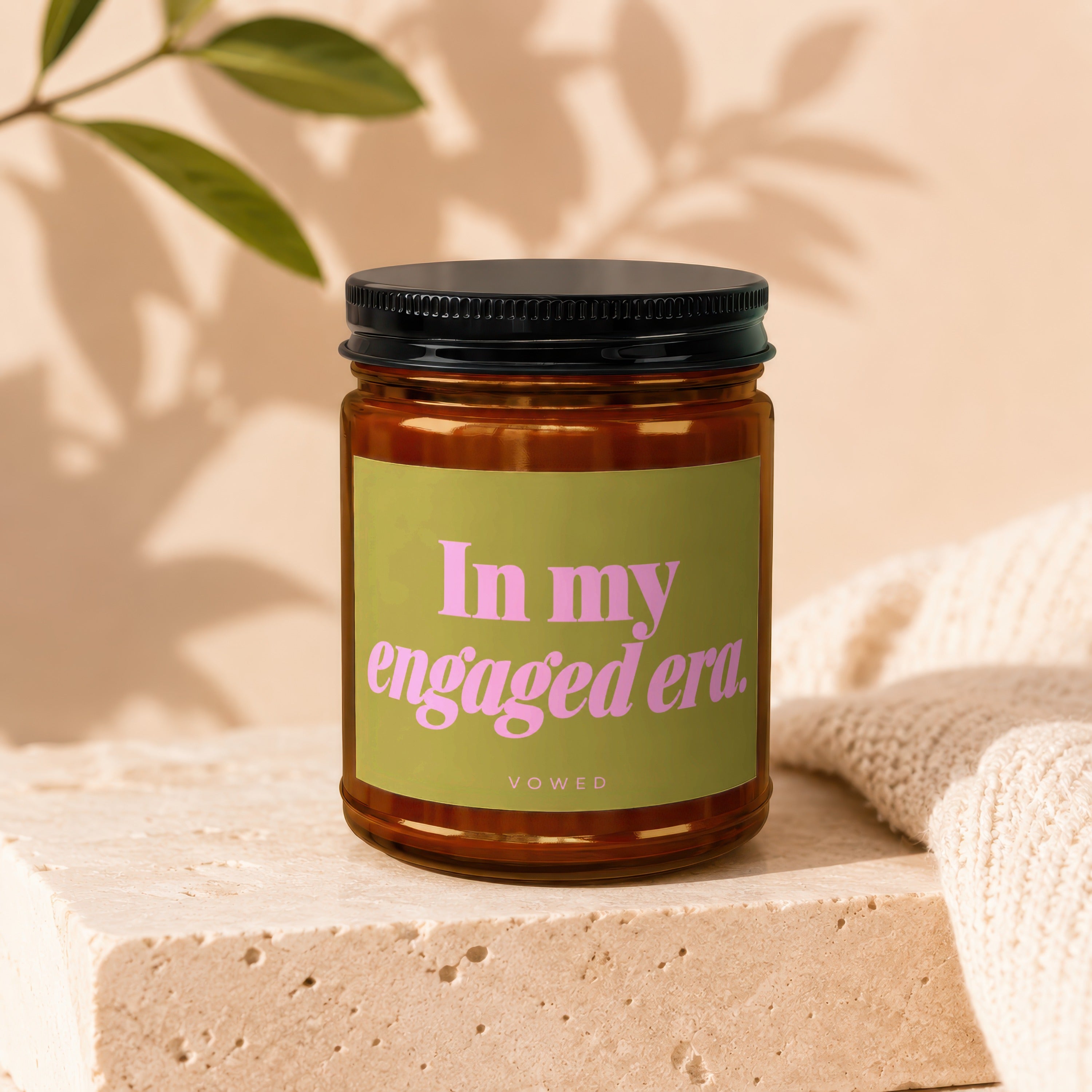 Amber candle with "In my engaged era." VOWED text on a lime green label.