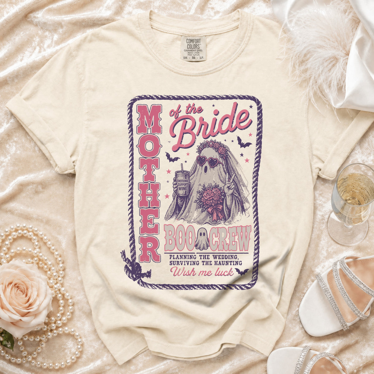 Cream t-shirt with "Mother of the Bride Boo Crew" graphic featuring a ghost bride and wedding planning text.