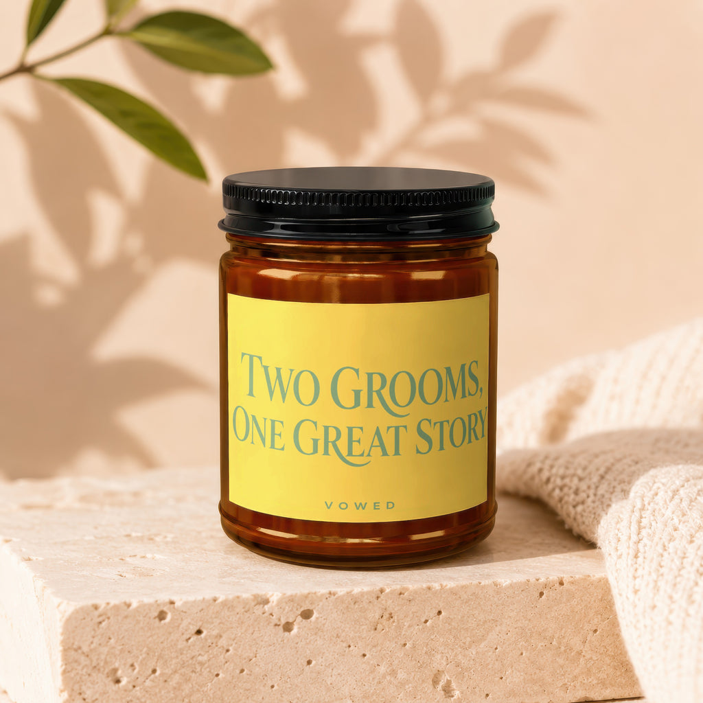 Brown glass candle with yellow label reading "TWO GROOMS, ONE GREAT STORY"