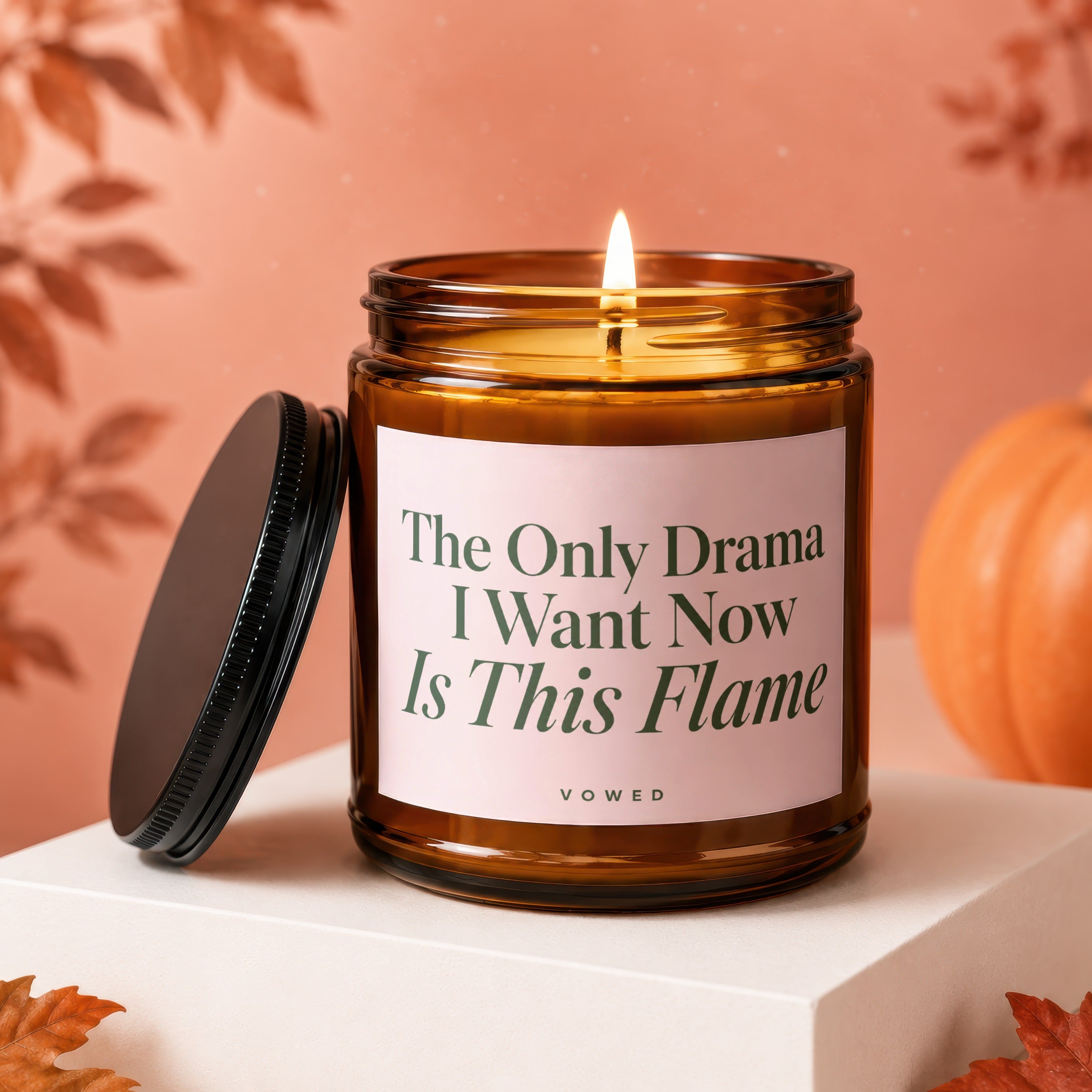 Amber jar candle with lit flame and text "The Only Drama I Want Now Is This Flame".